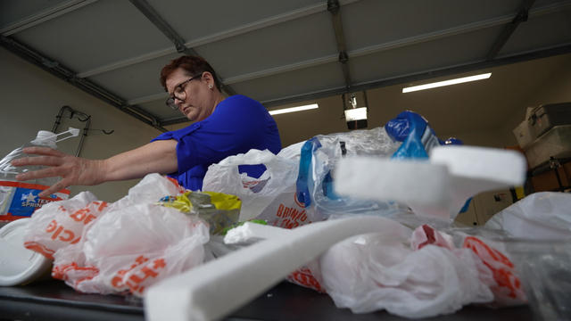 Brandy Deason sorting through plastic waste 