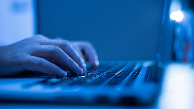 Hand of a man using laptop computer working at home 