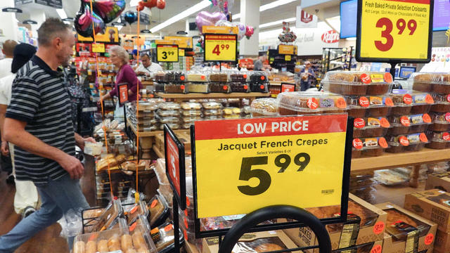 People shop in a grocery store 