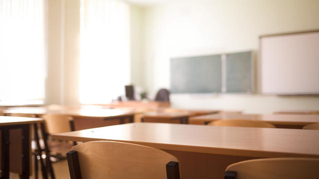 School classroom in blur background without young student; Blurry view of class room no kid or teacher with chairs and tables in campus. 