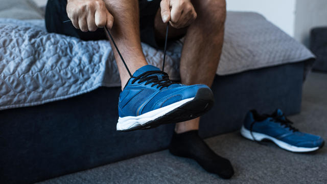 Man tying sneaker laces 